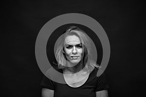 Dramatic black and white portrait of a beautiful woman on a dark background