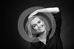 Dramatic black and white portrait of a beautiful woman on a dark background