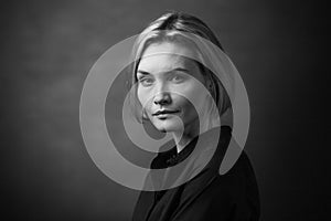 Dramatic black and white portrait of a beautiful woman on a dark background