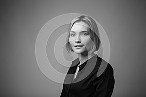 Dramatic black and white portrait of a beautiful woman on a dark background