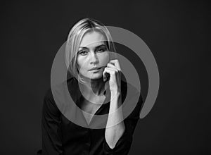 Dramatic black and white portrait of a beautiful woman on a dark background