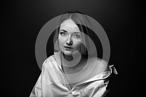 Dramatic black and white portrait of a beautiful woman on a dark background