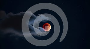 Dramatic Blood Moon Lunar Eclipse with Clouds in a Starry Night Sky