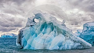 A dramatic blue iceberg in Antarctica.