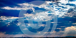 dramatic blue sky with clouds and sun rays