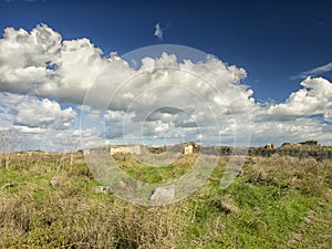 Dramatic blue sky with white clouds over the ruins of the ancient greek colony of Histria, on the shores of Black Sea. Histria is