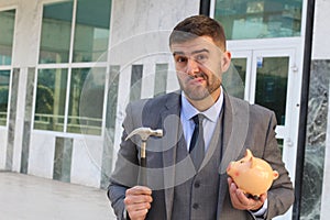 Dramatic businessman about to break his piggy bank