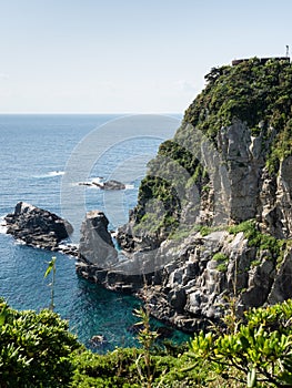 Dramatic cliffs of Cape Ashizuri with viewing platform on top