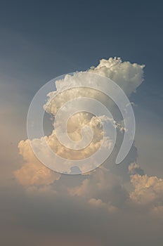 Dramatic cloud formation with interesting light and shadow against indigo blue sky as background