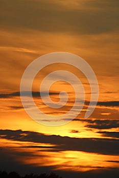 Dramatic clouds and colors, orange, yellow at sunset