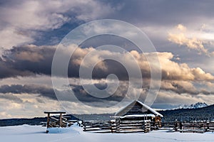 Dramatic clouds of evening over a quaint little corral in the Idaho mountains