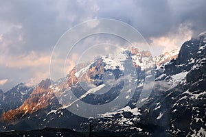 Dramatic clouds and light at the sunrise time over the Alps peaks