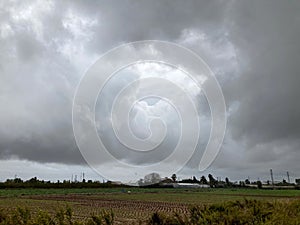 Dramatic clouds over the field in a rainy day