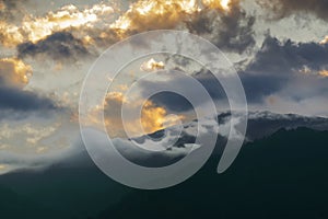 Dramatic clouds over Hiamalayan mountains after sun set, shot at Okhrey, Sikkim, India. Spectacular cloud formations making a