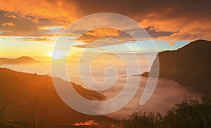 Dramatic Clouds rolling over mountains at sunset