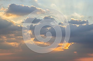 Dramatic clouds and shining form an interesting light pattern against the sky background