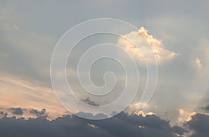 Dramatic clouds and shining form an interesting light pattern against the sky background