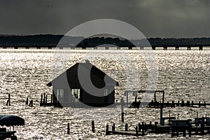 Dramatic Clouds and silhouetted eagles on the boathouse over the Rappahnnock River