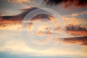 Dramatic clouds and sky in the night. Lights of a sunset through the cloudscape