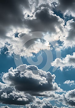 Dramatic Cloudscape: Blue Sky, Gray and White Cumulus Clouds with Sunlight