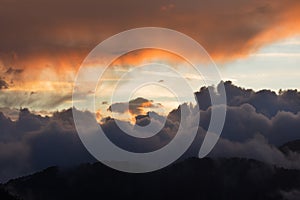 Dramatic cloudscape clouds sunset over mountains