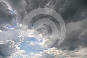 A dramatic cloudscape with heavy clouds and rays of light, creating a captivating atmosphere