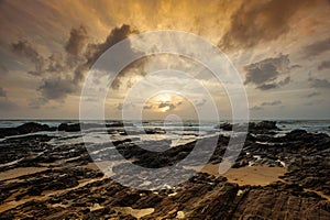 Dramatic cloudscape, rocky shoreline, ocean views at dawn, Dungun Terengganu, Malaysia