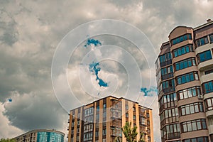 Dramatic cloudy gray city living apartments buildings perspective urban view with moody sky background, copy space