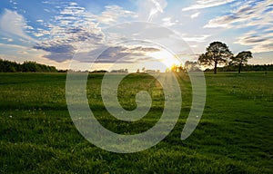 Dramatic sky at dusk over countryside fields in summer