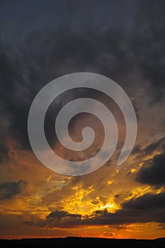 Dramatic cloudy twilight sky after sunset with orange red hues