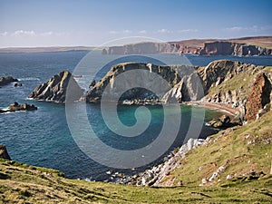 Dramatic coastal cliff scenery and a remote inaccessible beach on the Ness of Hillswick, Northmavine