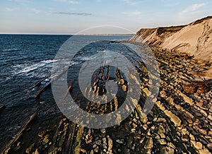 Dramatic coastal rock formations with layered striations