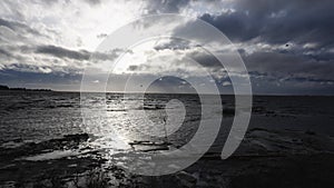 Dramatic Coastal Seascape with Cloudy Sky and Glinting Sunlight