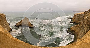 Dramatic coastline with intense colors in the desert of Paracas National Reserve