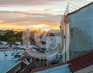 Dramatic color sunset rooftops of Madrid. Glowing fiery orange Madrid sky & rooftops at sunset.