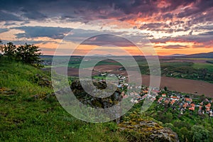 Dramatic, colorful sky at sunset on the rocks above the village.