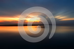 Smooth beach nature landscape bakground at sunrise with morning light over horizon.