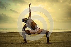 Dramatic contemporary dance choreographer doing ballet beach workout, young attractive and athletic afro black American man