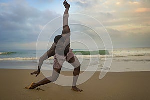 Dramatic contemporary dance choreographer doing ballet beach workout, young attractive and athletic afro black American man