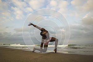 Dramatic contemporary dance choreographer doing ballet beach workout, young attractive and athletic afro black American man