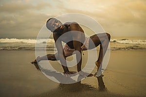 Dramatic contemporary dance choreographer doing ballet beach workout, young attractive and athletic afro black American man