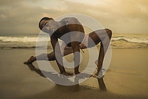 Dramatic contemporary dance choreographer doing ballet beach workout, young attractive and athletic afro black American man