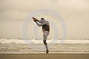 Dramatic contemporary dance choreographer doing ballet beach workout, young attractive and athletic afro black American man