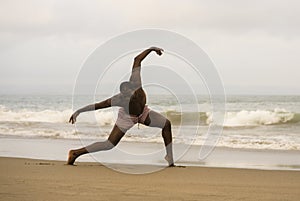 Dramatic contemporary dance choreographer doing ballet beach workout, young attractive and athletic afro black American man