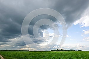 Dramatic countryside landscape with thunderclouds in the sky over a wheat field