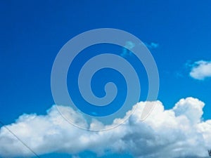 Dramatic cumulus clouds forming under a bright blue sky