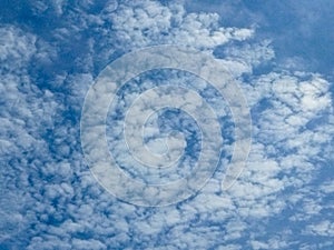 Dramatic cumulus clouds forming under a bright blue sky