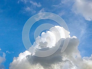 Dramatic cumulus clouds forming under a bright blue sky