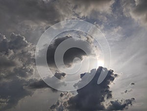 Dramatic dark clouds with sun shining behind