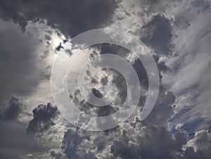 Dramatic dark clouds with sun shining behind